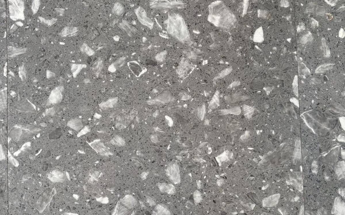 Polished gray terrazzo with light and dark stone chips, illustrative photo
