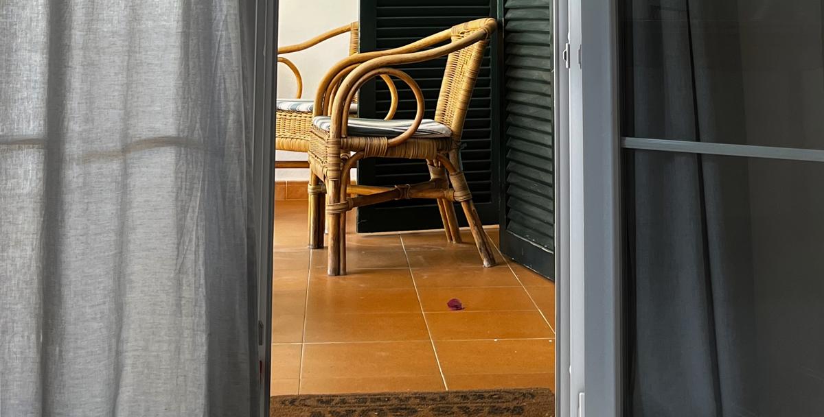 Terrace doorway opening onto a terrazzo floor, illustrative photo